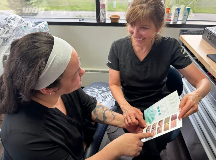 Leanne showing a patient facial aesthetics treatments like Botox and fat reduction in Anchorage